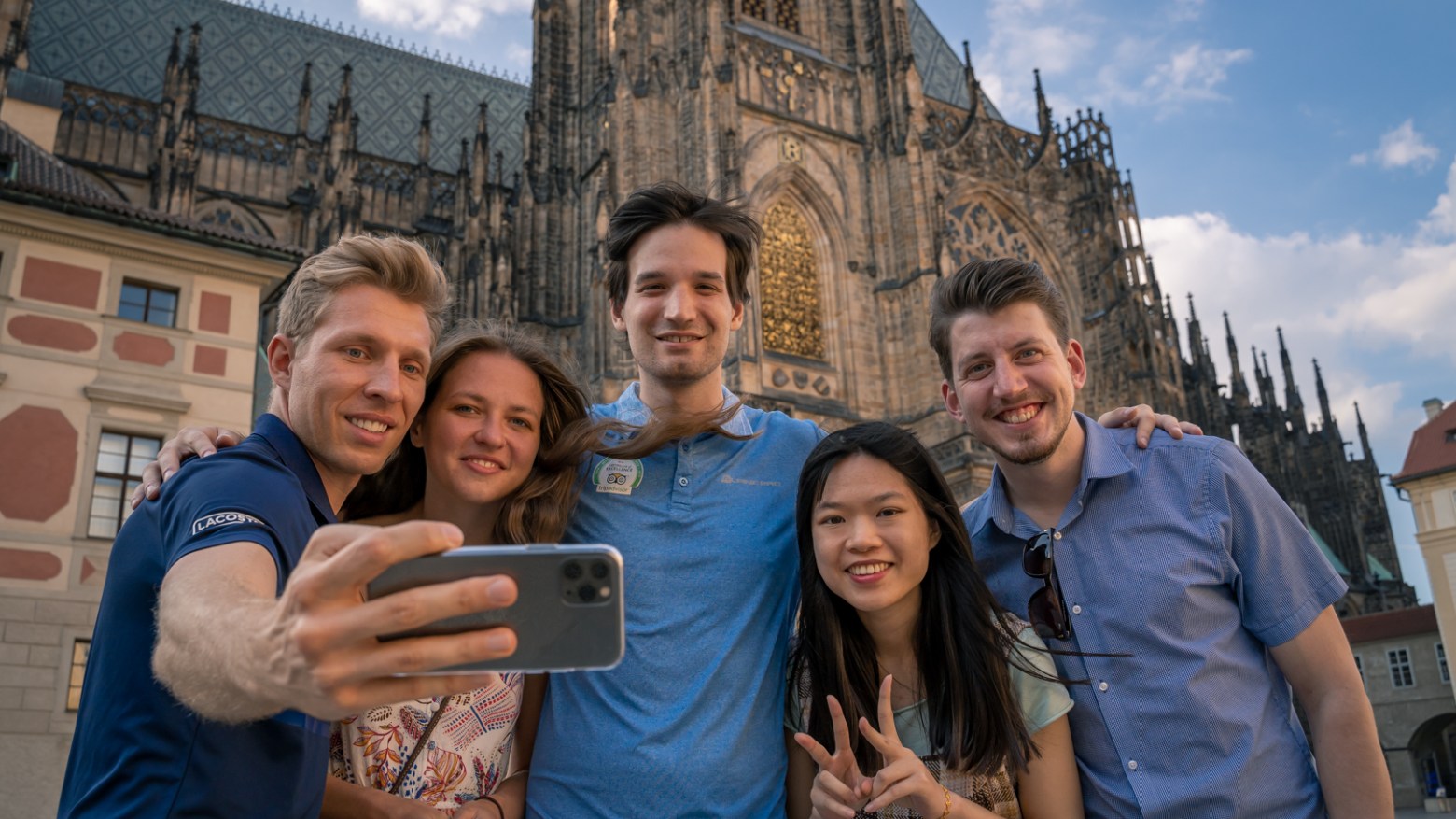 a group of people posing for a photo in front of a building