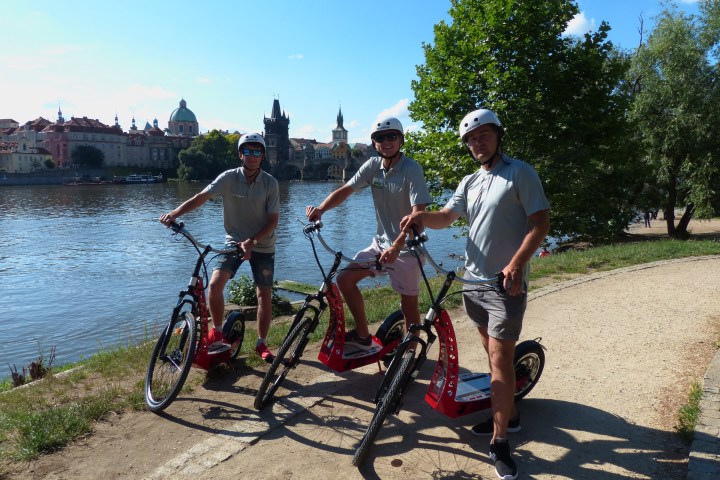 a group of people riding on the back of a bicycle