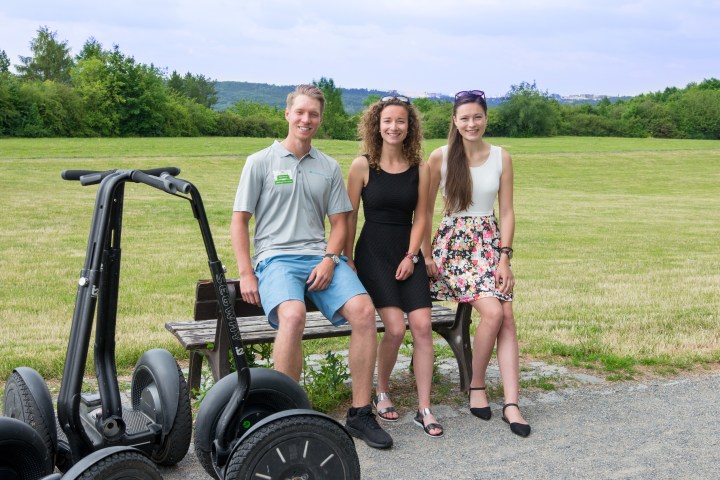 a man and a woman sitting on a motorcycle