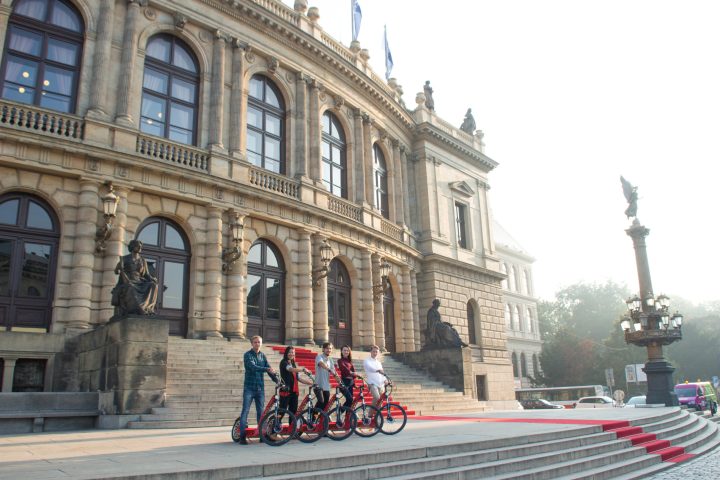 a group of people walking in front of a building