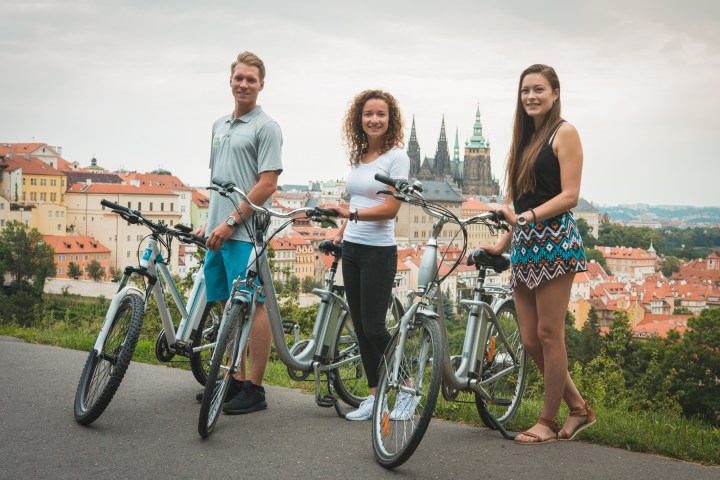 a man and a woman standing next to a bicycle