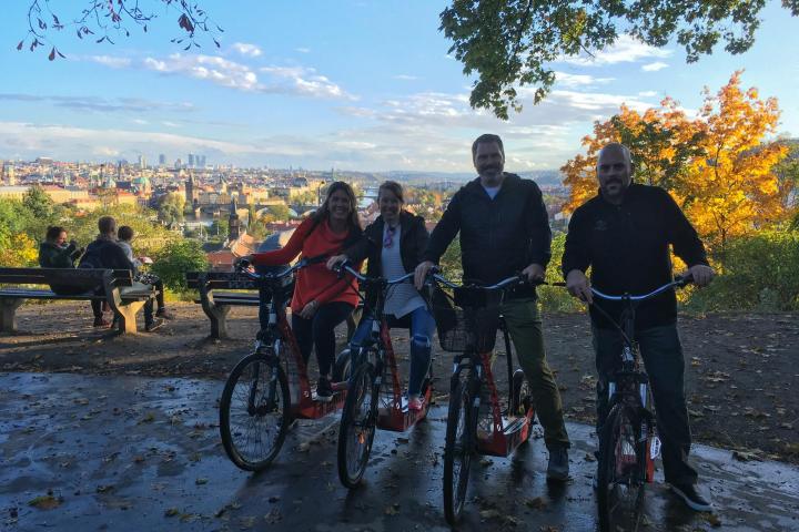 a group of people riding on the back of a bicycle