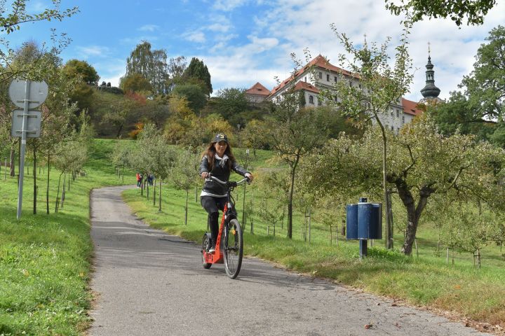 a man riding a bike down a dirt road