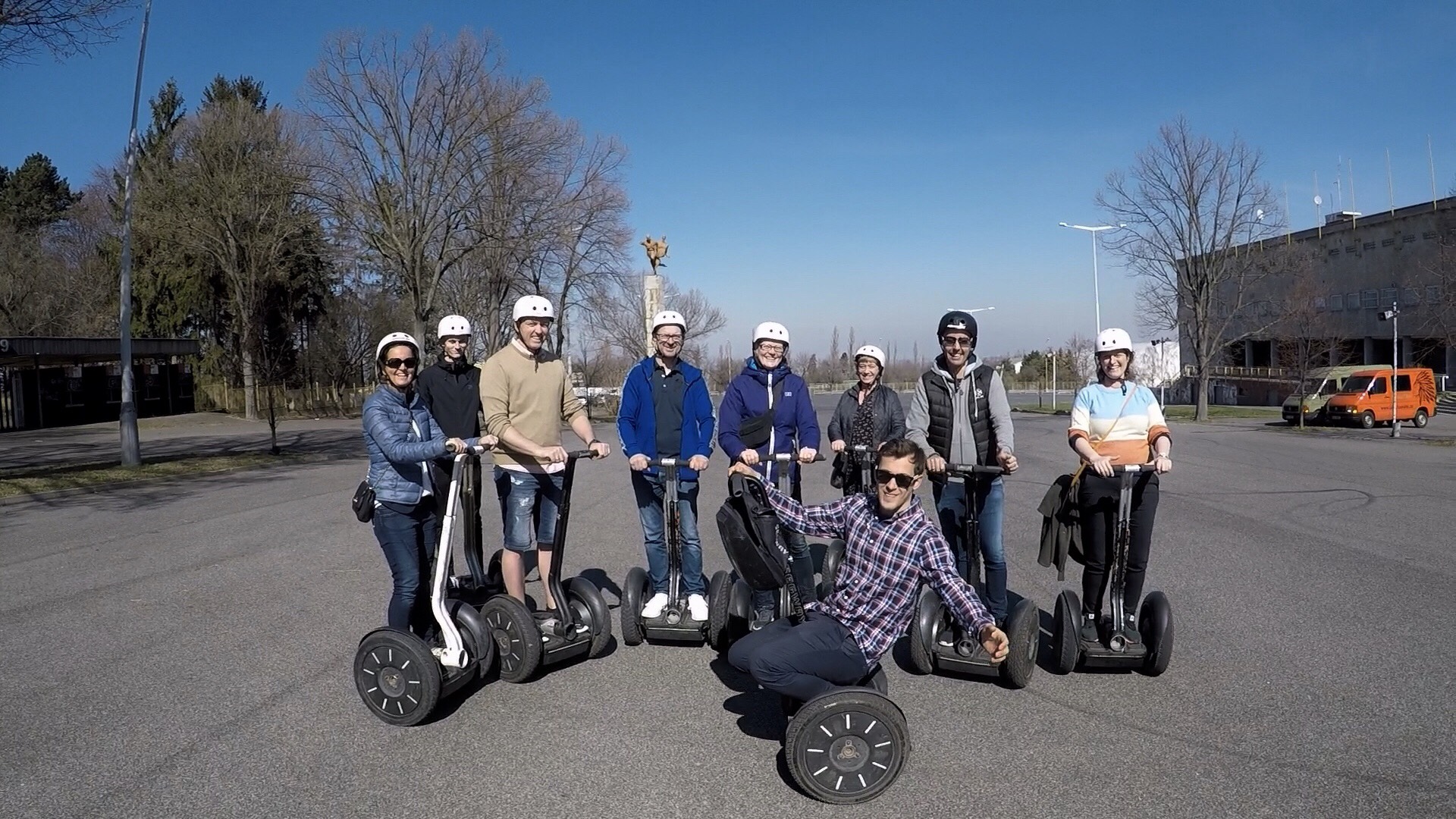 a group of people posing in a parking lot
