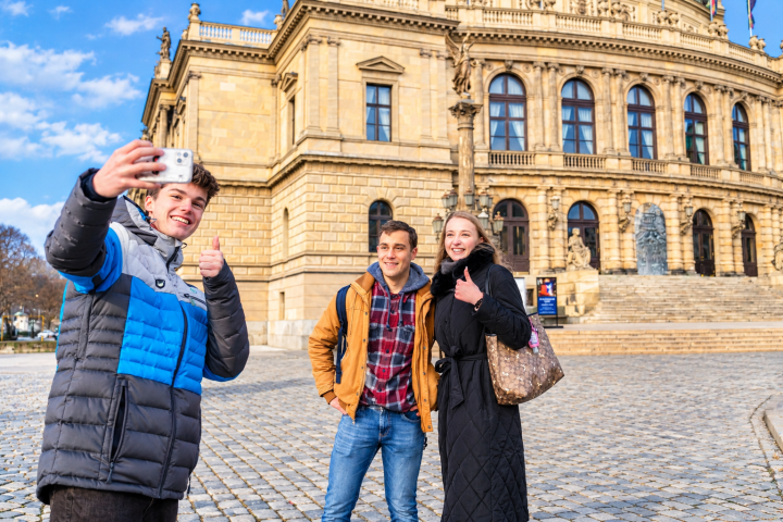 Three people taking a selfie in front of a historic building.