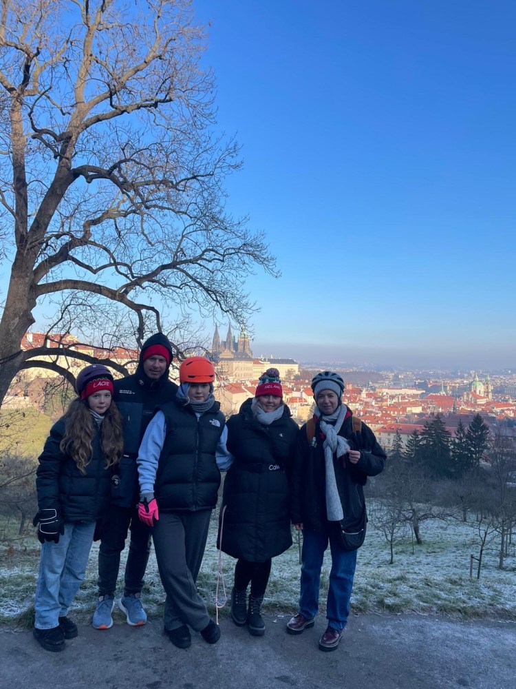 a group of people standing next to a tree