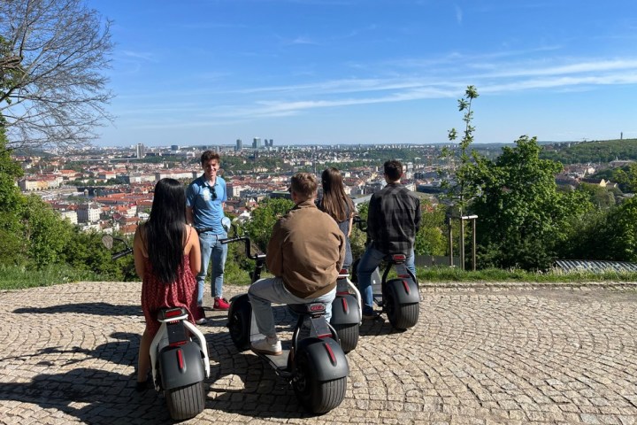 a group of people standing on a dirt road