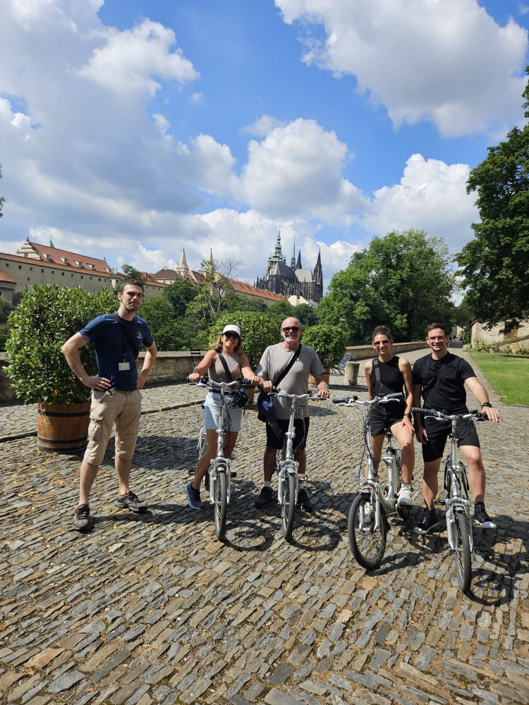 a group of people standing next to a bicycle