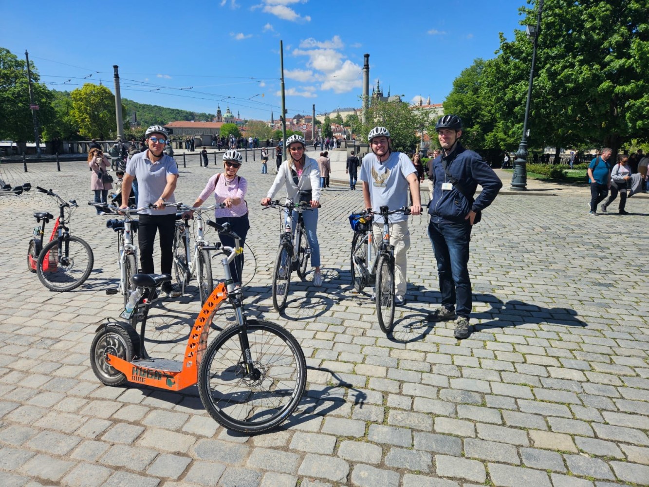 a group of people riding on the back of a bicycle